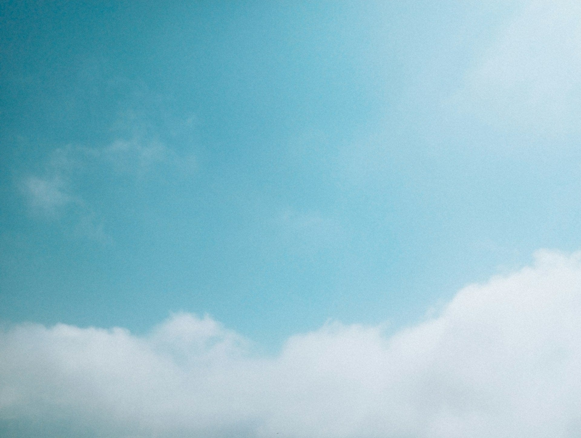 Clear blue sky with a few scattered clouds
