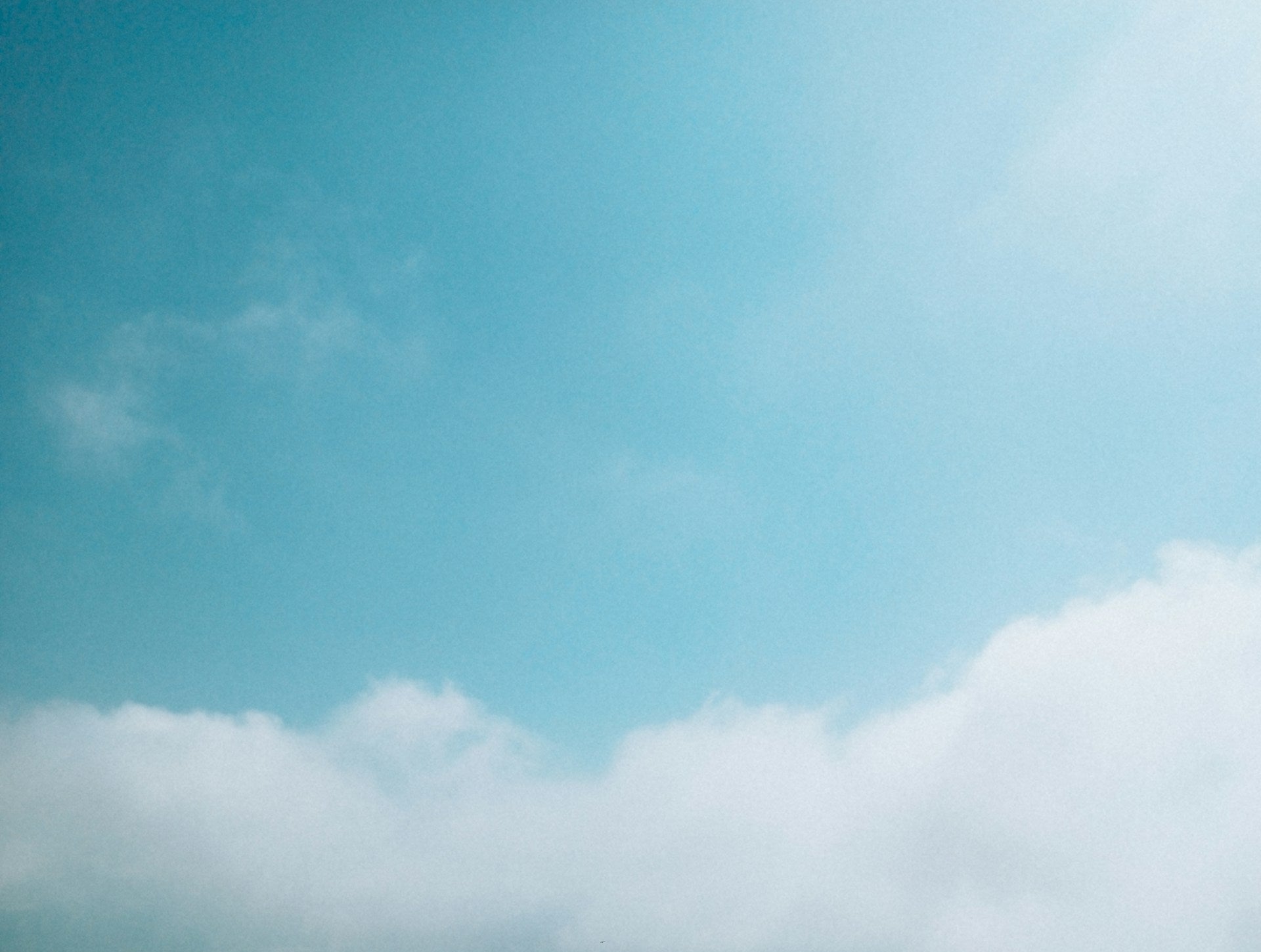 Clear blue sky with a few scattered clouds